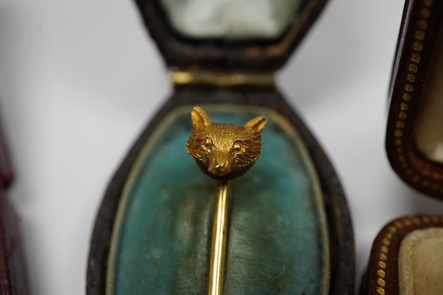 A group of gentleman's accessories, early 20th century, comprising: two pairs of cultured pearl collar studs, one set marked 15CT, each with fitted cases; a stick pin topped with the head of a fox, indistinct mark to pin